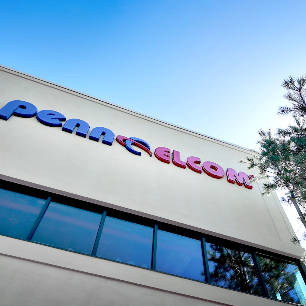 Penn Elcom logo sign on white building against blue sky