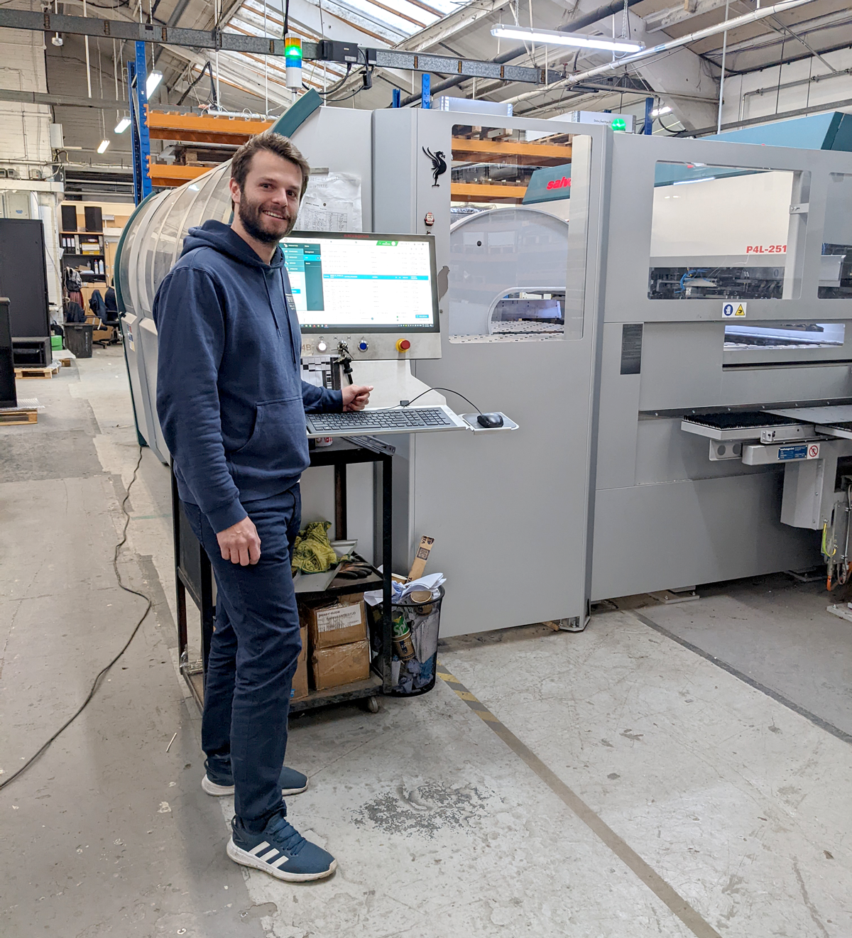 Adam standing at a machine