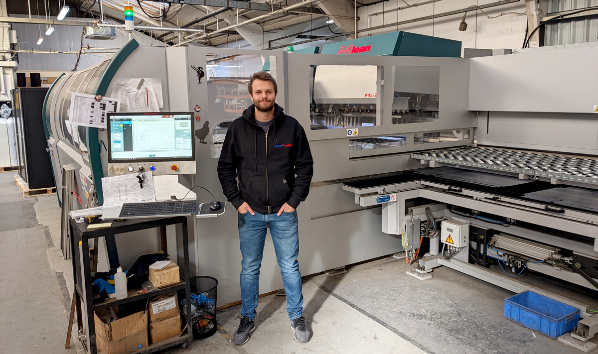 A bigger shot of Adam standing in front of P4 Lean Salvagnini machine