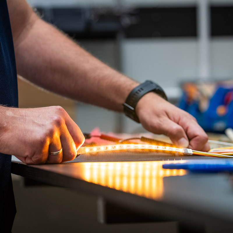 Person testing LED light strip