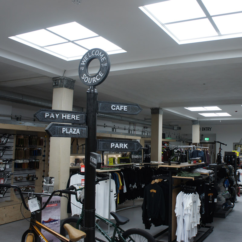 Source Skate Park retail space with sign post, lighting and products on rails 