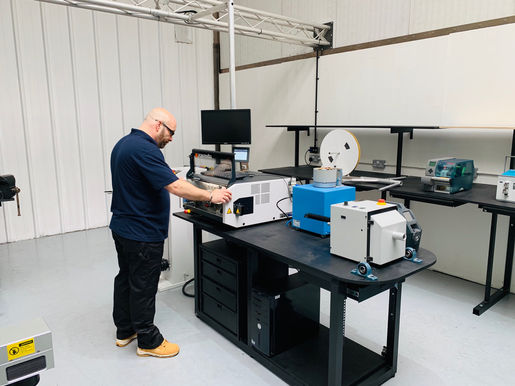 Leon using a machine in the cabling department