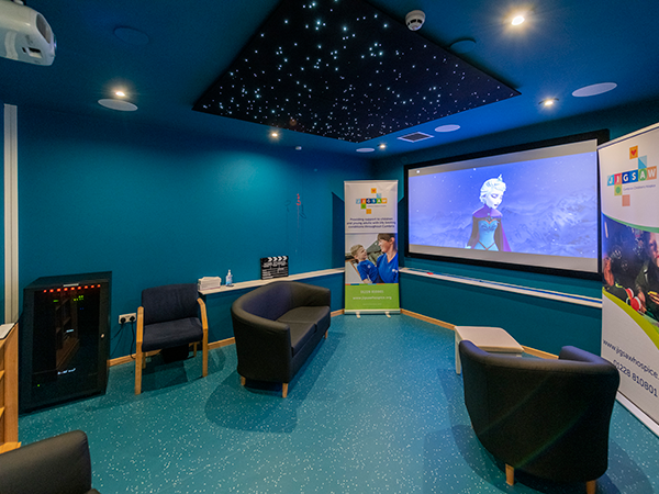 Frozen projected onto a screen with starry night ceiling for Jigsaw Hospice