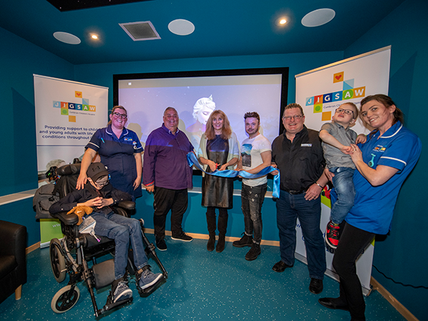Carers and attendees standing for photo, happy to recieve this gift