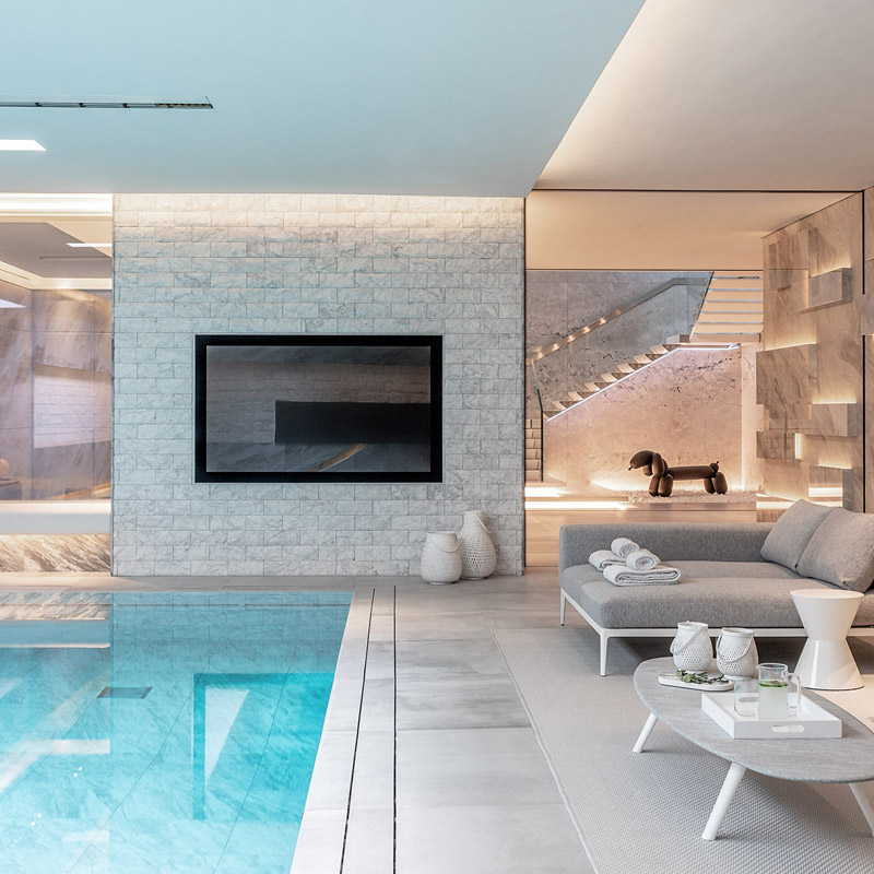 Pool area of IO house with skylight, LED lighting, staircase and dog sculpture