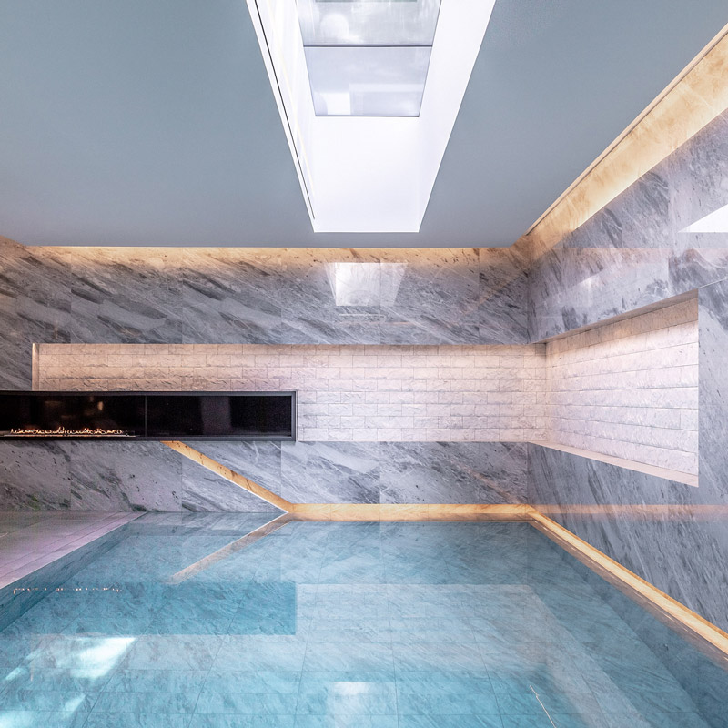 IO House London interior pool area showing LED lighting with skylight reflecting in the water - dpa lighting and Taran Wilkhu