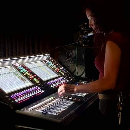 Laura at the AV desk, managing the stage craft