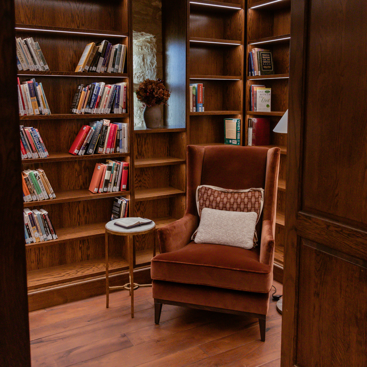 Lanier Theological Library nook with brown armchair, books and shelves with LED lights