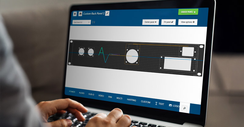 Person using Panel Designer on laptop with AV logo and connector cut outs on panel