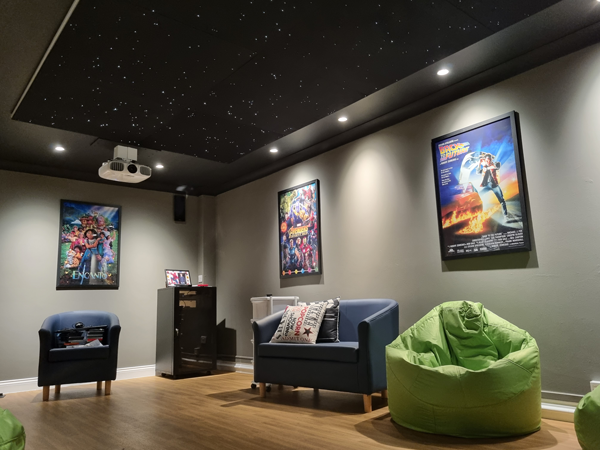 Casual seating with film posters (Encanto, Avengers, Back to the Future)