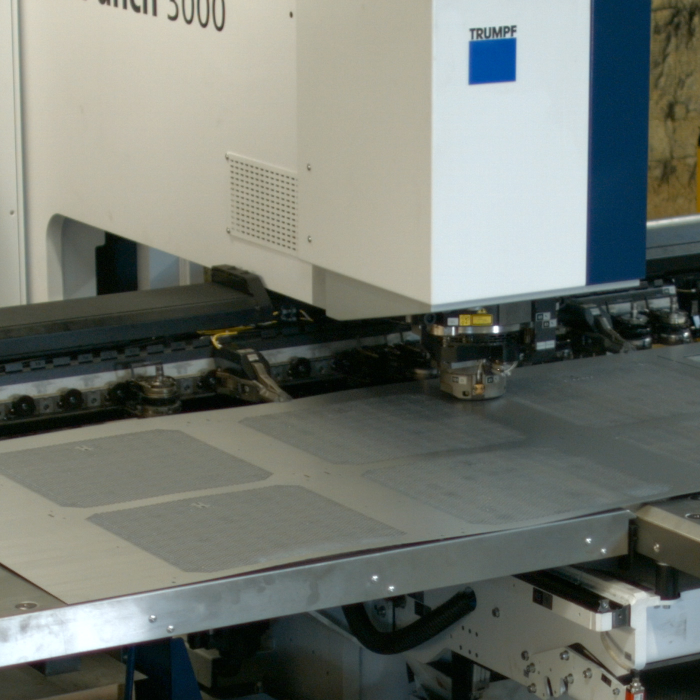 Trumpf punching machine punching holes and perforations into metal sheet