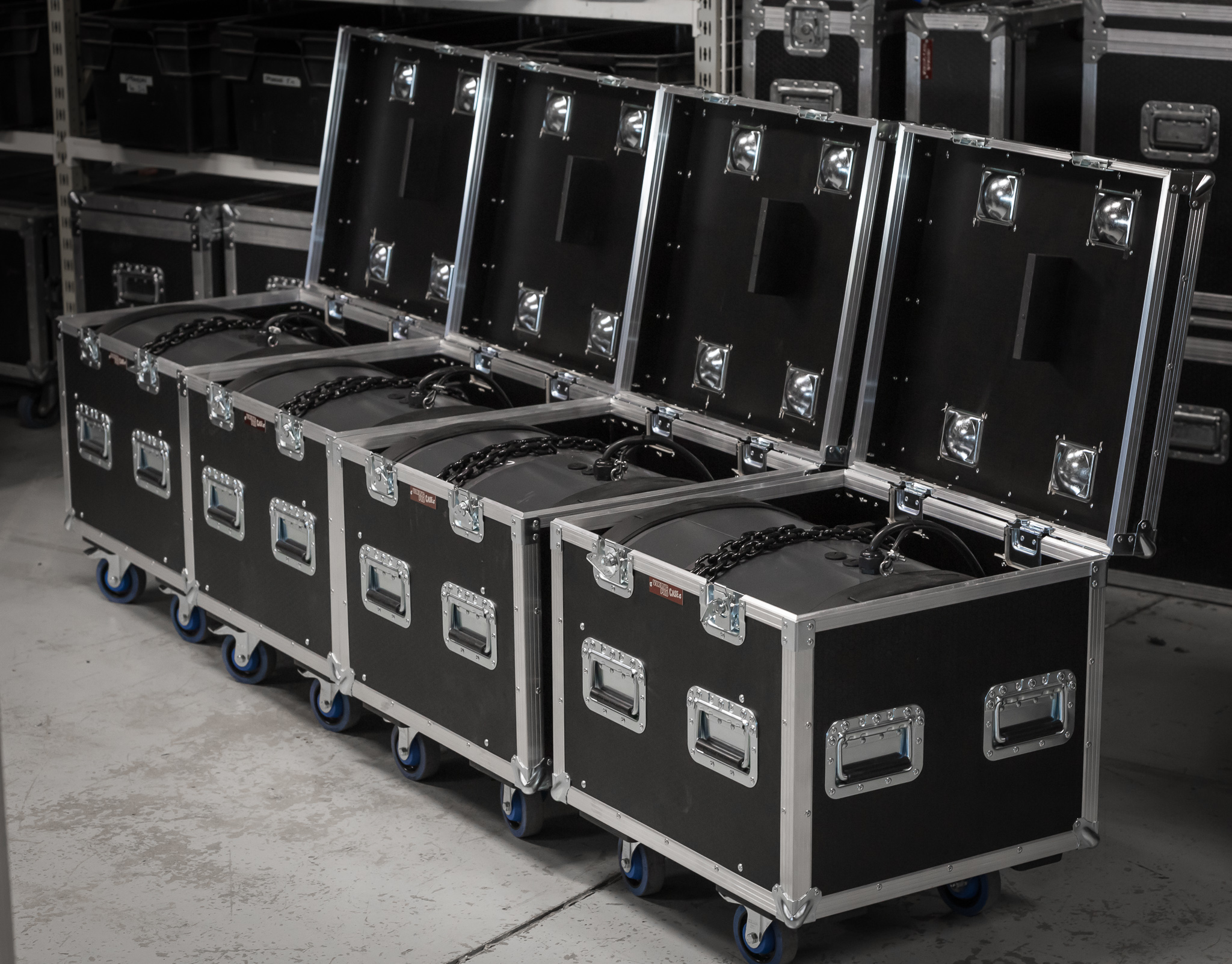 A row of flight cases with a drum kit in place