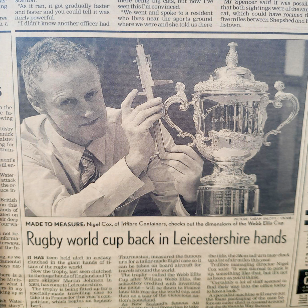 Webb Ellis Trophy fror the Rugby World Cup in old newspapper